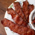 Crispy turkey bacon slices on a glass plate