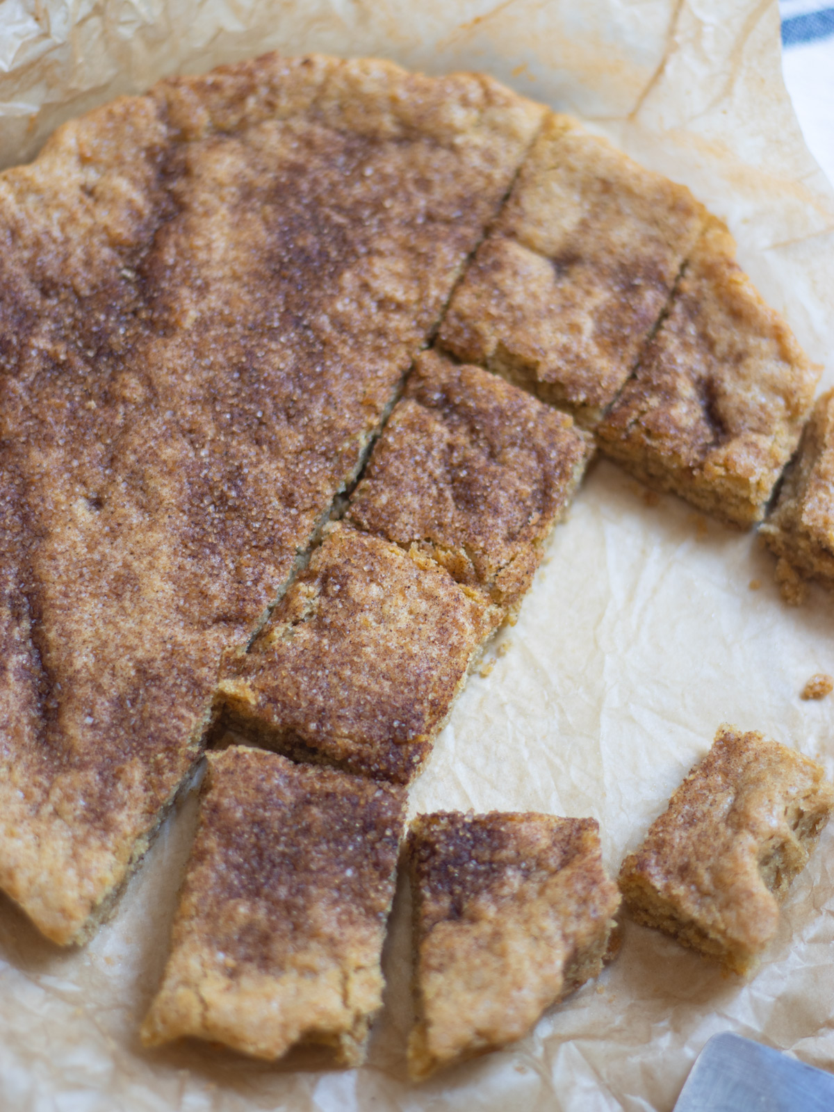 snickerdoodle bars on a sheet of parchment paper
