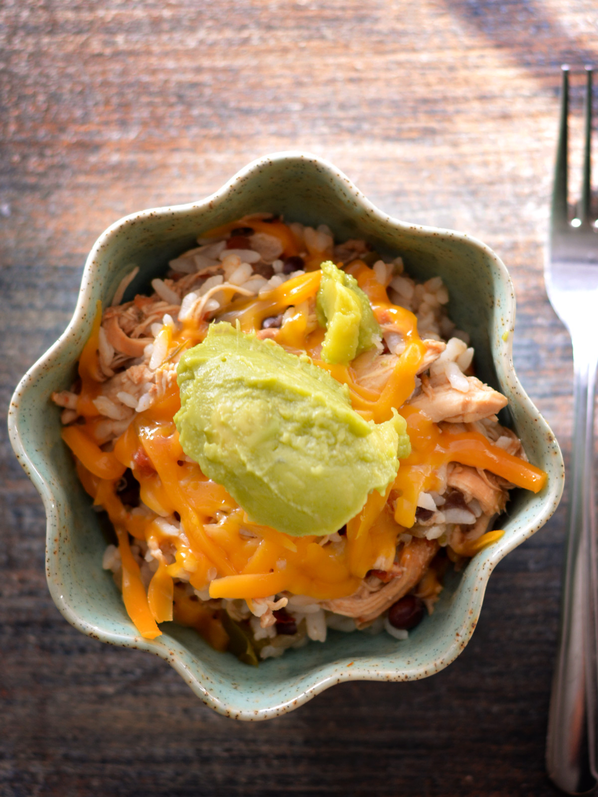 This easy slow cooker recipe combines tender chicken with fluffy rice, black beans, smoky ancho chili and other seasonings, and vibrant diced tomatoes for a comforting, flavorful meal. Perfect for a fuss-free, hearty dinner.