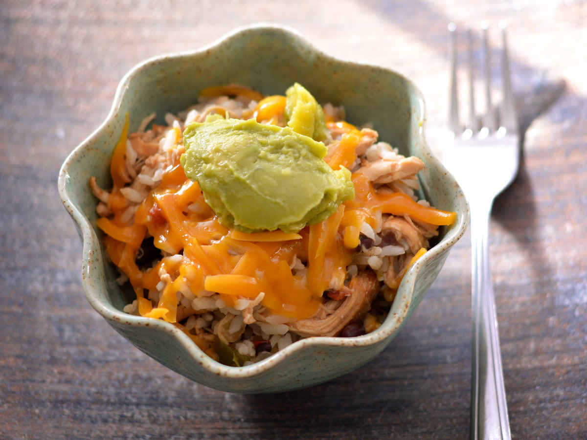 This easy slow cooker recipe combines tender chicken with fluffy rice, black beans, smoky ancho chili and other seasonings, and vibrant diced tomatoes for a comforting, flavorful meal. Perfect for a fuss-free, hearty dinner.