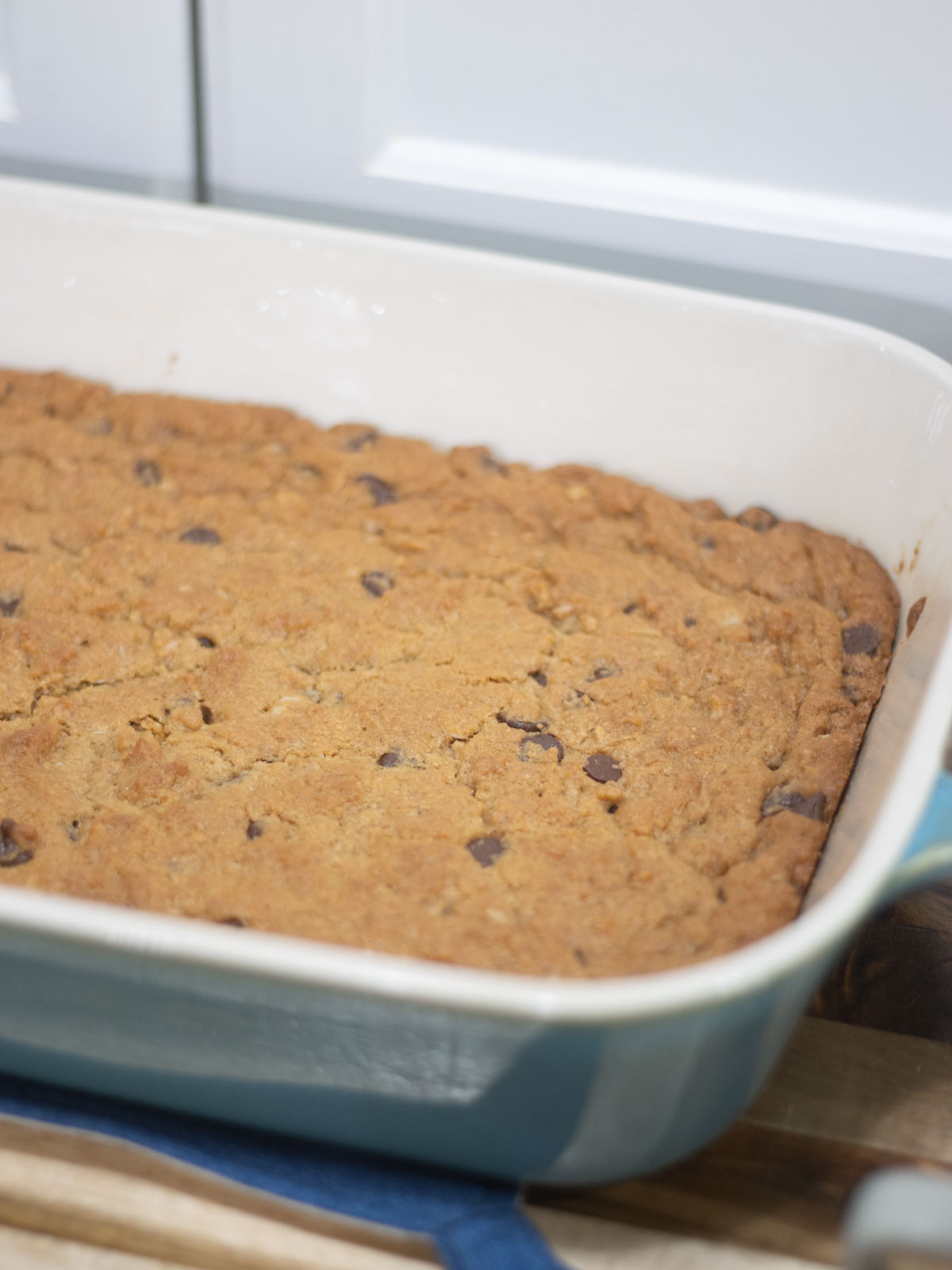baked triple cookie bars in a stoneware baking pan
