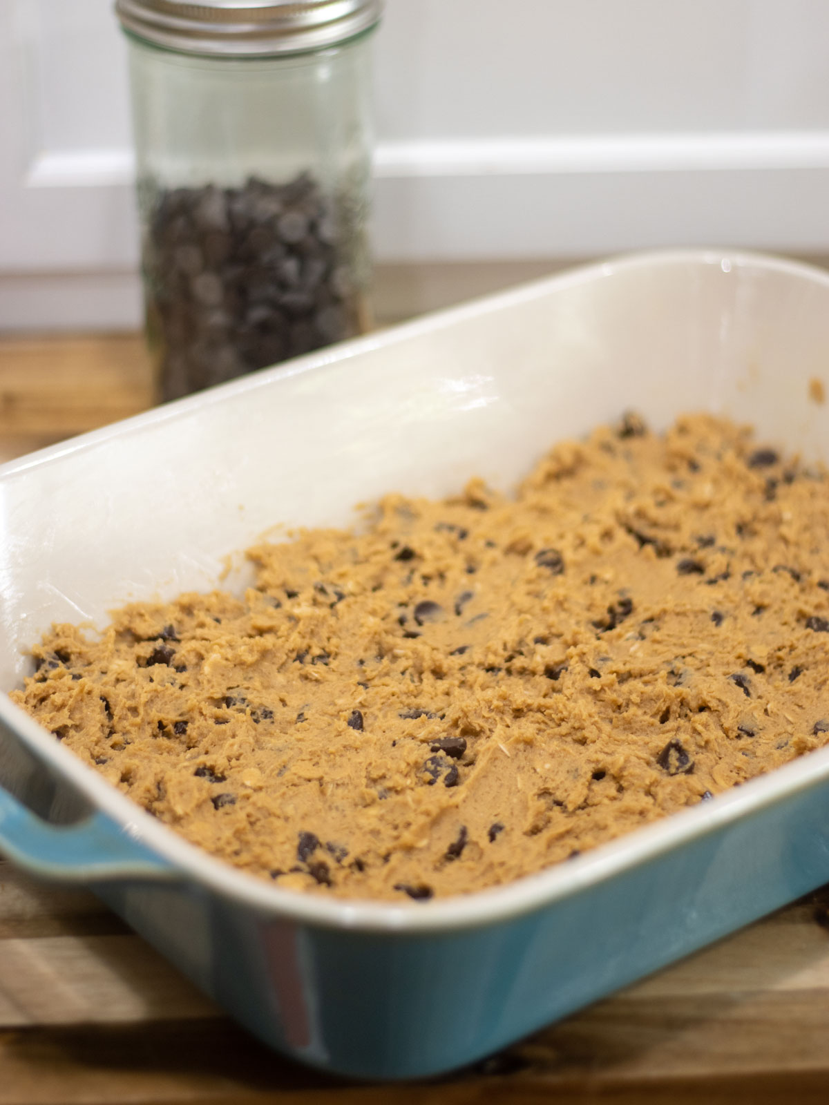 unbaked triple cookie bars in a baking dish
