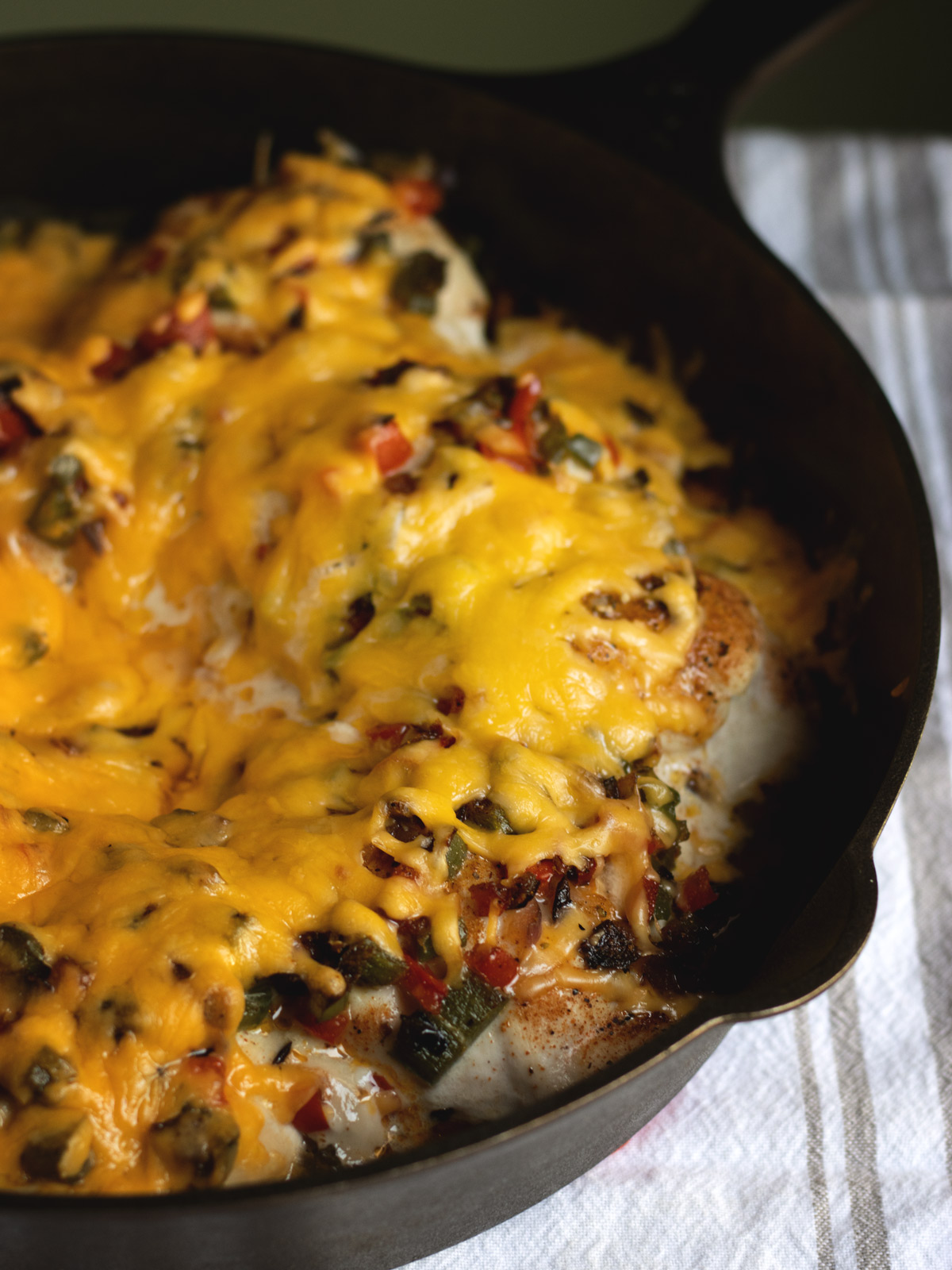 Cajun Stuffed Chicken is a bold, flavor-packed dinner that feels a little fancy without being fussy. Juicy chicken breasts are filled with sauteed peppers and onion with a Cajun kick, and smothered in bubbling, melty cheese.